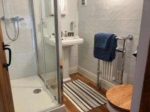 a bathroom with a shower and a sink at The Dale at Greystones - Luxurious annexe with stunning view in Buckden