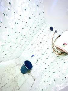 a bathroom with a blue bowl on the floor at Amaravathi Home Stay in Tiruvannāmalai