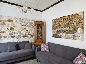 a living room with two couches and a painting on the wall at Dreamer's Home Chrisa in Limenas