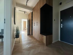 a hallway with a flat screen tv in a house at Stylish 3 bedroom apartment with balcony in Płock