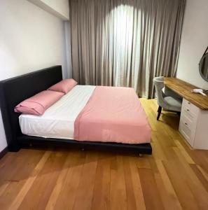 A bed or beds in a room at Regalia Home Stay