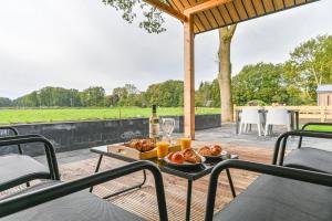 a table with a plate of food and a glass of wine at HUB Resorts Drentse Weelde in Hoogersmilde