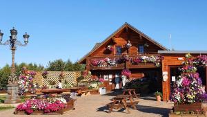 a wooden building with flowers in front of it at Griffon Lodge in Morpeth