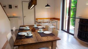 a dining room with a wooden table and chairs at WoodBnb in Cassina Rizzardi +5 photos