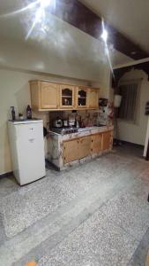 a kitchen with a white refrigerator and a stove at Résidence Gharnata in Marrakech