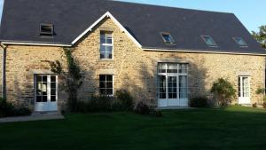 a brick house with a black roof at Maison Leonard in Vains