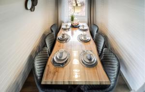 a long wooden table with black chairs around it at Ferienhaus 107 In Kirchheim in Kemmerode