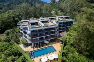 an aerial view of a building with a swimming pool at Luxury Rooftop Penthouse in Ban Nakhale