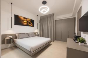 a bedroom with a bed and a painting on the wall at Luxury Station Suite in Bologna
