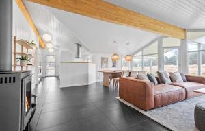 uma sala de estar com um sofá e uma mesa em Beautiful Home In Blvand With Sauna em Blåvand