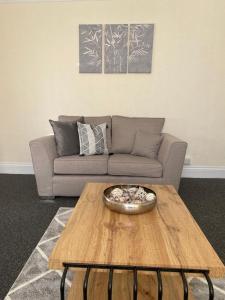 a living room with a couch and a coffee table at Chepstow House (5 BR with FREE on-steet parking) in Newport