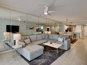 a living room with a couch and a table at The Pearl Of Navarre 705 in Navarre