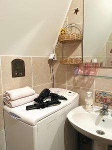 a bathroom with a sink and a phone on a counter at Bloossom house in Bajina Bašta