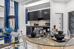 a dining room with a glass table and chairs at Luxury Two Bedroom Flat right opposite to Harrods KB15 in London