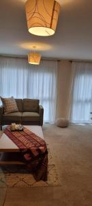 a living room with a couch and a table at Stunning 2-Bed Apartment near Colindale Station in Hendon
