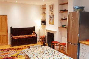 a living room with a bed and a fireplace at Stylish Victorian House in Watford