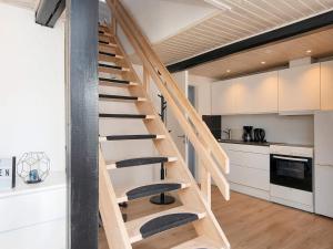 a wooden staircase in the kitchen of a house at 6 person holiday home in Sydals-By Traum in Østerby