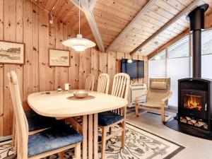 a dining room with a table and a fireplace at 6 person holiday home in Ålbæk-By Traum in Ålbæk +44 photos
