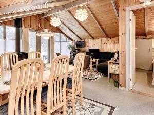 a dining room and living room with a table and chairs at 6 person holiday home in Ålbæk-By Traum in Ålbæk