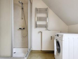 a bathroom with a washing machine and a shower at Holiday home Faaborg XXVII in Fåborg