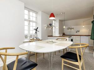 a kitchen and dining room with a white table and chairs at Holiday home Faaborg XXVII in Fåborg