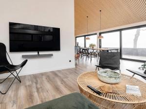 a living room with a large flat screen tv on a wall at 5 star holiday home in Frederikshavn-By Traum in Frederikshavn