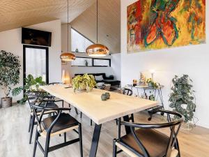 a dining room with a large table and chairs at Holiday home Frederikshavn IV in Frederikshavn