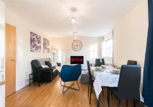 a living room and dining room with a table and chairs at Derby Parliament Spacious 2Bedroom Apartment with Parking in Derby