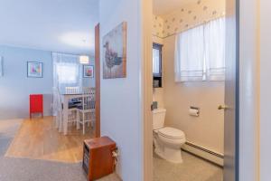 a bathroom with a toilet and a dining room at The Cozy Harriet Log Home in Fairbanks +63 photos