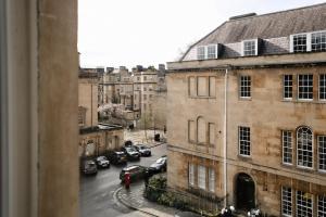 a view from a window of a city street with cars at Cambridge House in Bath