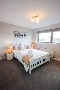 a bedroom with a large white bed with two lamps at City Retreat by the Castle Free Designated Parking in Stirling