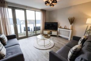 a living room with a couch and a table at City Retreat by the Castle Free Designated Parking in Stirling