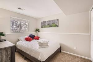 a bedroom with a bed with red pillows on it at Centrally located for adventures in Westminster