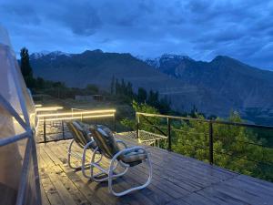 two chairs on a deck with a view of mountains at SG Glamping Resort in Hunza
