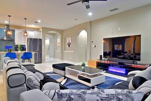 a large living room with couches and a tv at Stunning 6 Bedroom Near Downtown in San Antonio