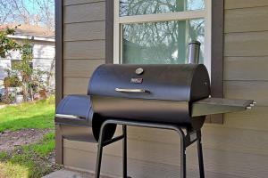 a barbecue grill sitting outside of a house at Stunning 6 Bedroom Near Downtown in San Antonio