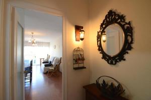 a hallway with a mirror and a living room at ROCAMAURA 3 - L'Estartit in L'Estartit +15 photos