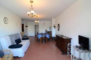 a living room with a white couch and a tv at ROCAMAURA 3 - L'Estartit in L'Estartit