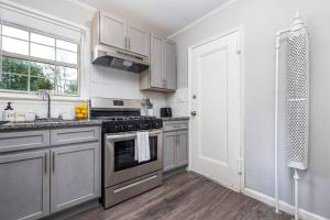 a kitchen with stainless steel appliances and a window at King Bed Apt in West Hartford - Sleep 04 in Great Neighborhood in West Hartford
