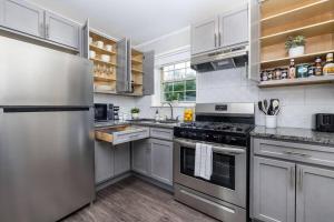 a kitchen with stainless steel appliances and white cabinets at King Bed Apt in West Hartford - Sleep 04 in Great Neighborhood in West Hartford