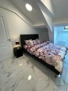 a bedroom with a bed with a floral comforter at Cozy apartment in Monaco center in Monte Carlo