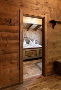 an open door to a bedroom in a log cabin at Chalet Edelweiß in Saalbach-Hinterglemm