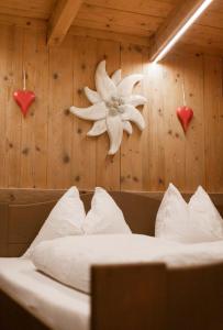 a bedroom with a bed with a flower on the wall at Chalet Edelweiß in Saalbach-Hinterglemm
