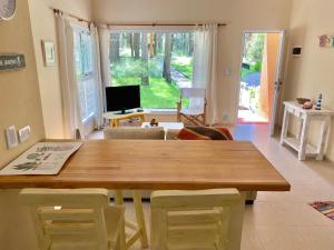 a dining room with a wooden table and chairs at Casa Libertad in Mar de las Pampas +9 photos