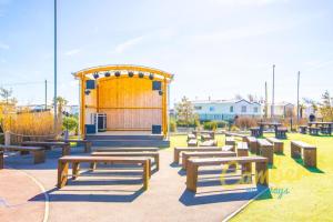 a group of wooden benches in a park at MP250 Camber Sands Holiday Park in Camber
