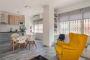 a kitchen and dining room with a table and chairs at BNBHolder Calm Duplex Retiro Free Parking in Madrid