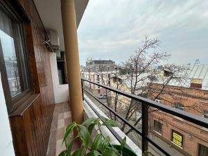 a balcony with a view of a city at Hotel Home in Tbilisi City