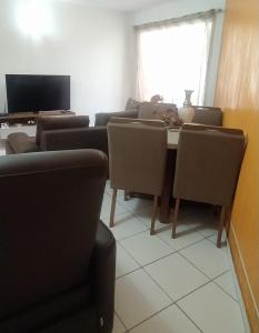 een kamer met stoelen, een tafel en een televisie bij ApartamentoTop Praia Jacarecica 200mts da praia in Maceió
