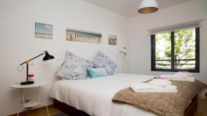 - une chambre avec un lit blanc et une fenêtre dans l'établissement Apartamento Oura Mar - By Dalma Portuguesa, à Albufeira