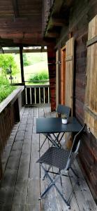 a blue table and a chair on a porch at HOCHDÜRRNBERG WATZMANN Doppelzimmer mit Bad Balkon Gästeküche - Frühstück optional in Dürrnberg